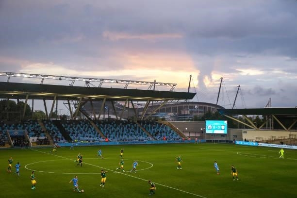 General view of match action as Etihad Stadium, home stadium of Manchester City is seen in the background during dusk during the Pre Season Friendly...