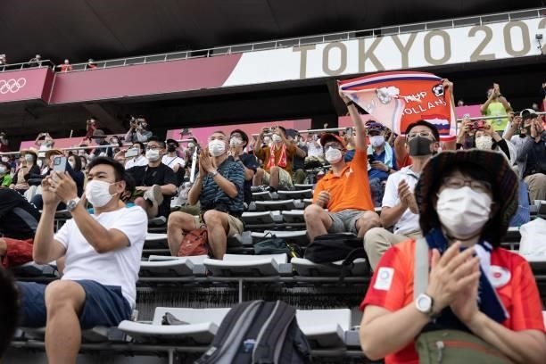 Fans cheer from the spectator stands during the victory ceremony for the men's cycling road individual time trial during the Tokyo 2020 Olympic Games...