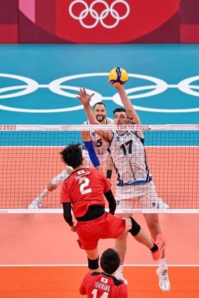 Italy's Simone Anzani hits the ball in the men's preliminary round pool A volleyball match between Japan and Italy during the Tokyo 2020 Olympic...