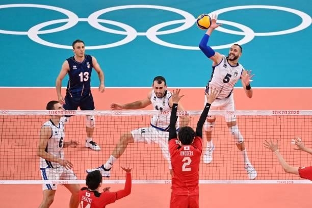 Italy's Osmany Juantorena hits the ball in the men's preliminary round pool A volleyball match between Japan and Italy during the Tokyo 2020 Olympic...