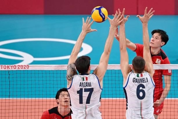 Japan's Yuji Nishida hits the ball in the men's preliminary round pool A volleyball match between Japan and Italy during the Tokyo 2020 Olympic Games...