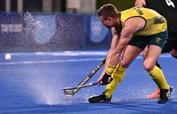 Australia's Tom Joseph Wickham strikes the ball during the men's pool A match of the Tokyo 2020 Olympic Games field hockey competition against New...