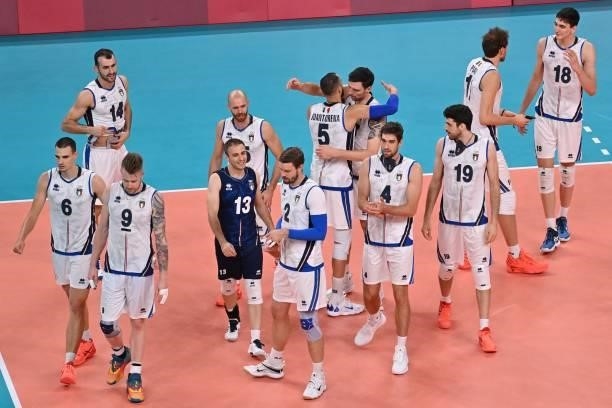 Italy's players celebrate their victory in the men's preliminary round pool A volleyball match between Japan and Italy during the Tokyo 2020 Olympic...