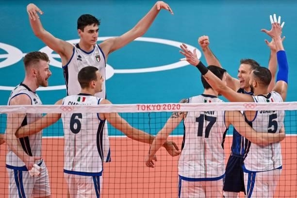 Italy's players react after a point in the men's preliminary round pool A volleyball match between Japan and Italy during the Tokyo 2020 Olympic...