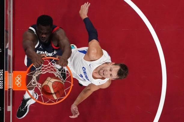 France's Moustapha Fall scores a basket as Czech Republic's Jan Vesely reacts in the men's preliminary round group A basketball match between France...