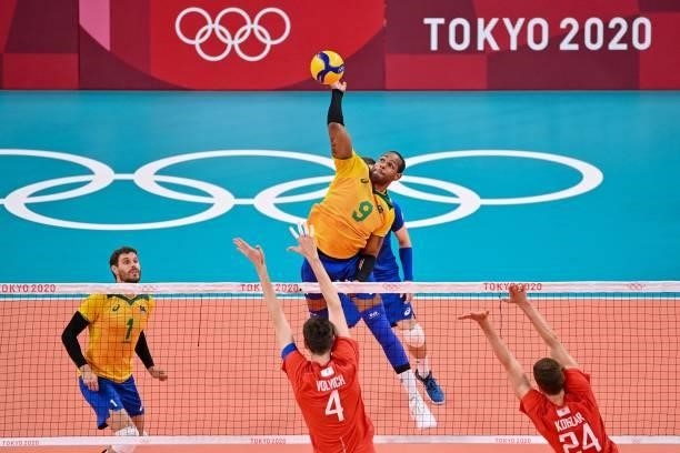 Brazil's Yoandy Leal Hidalgo spikes the ball in the men's preliminary round pool B volleyball match between Brazil and Russia during the Tokyo 2020...