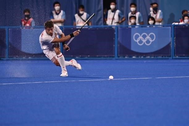 Spain's Marc Salles strikes the ball during the men's pool A match of the Tokyo 2020 Olympic Games field hockey competition against Japan, at the Oi...