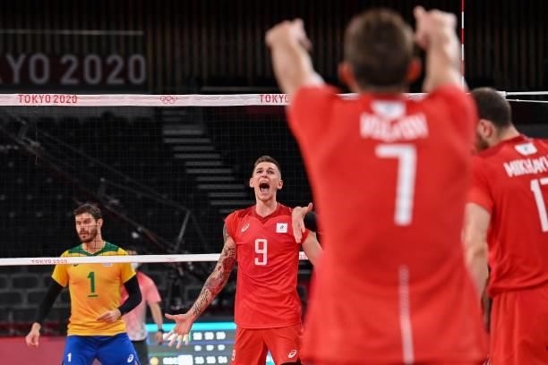 Russia's Ivan Iakovlev celebrates their victory in the men's preliminary round pool B volleyball match between Brazil and Russia during the Tokyo...