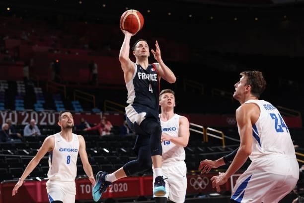 France's Thomas Heurtel goes to the basket as Czech Republic's Jan Vesely and Tomas Satoransky watch in the men's preliminary round group A...
