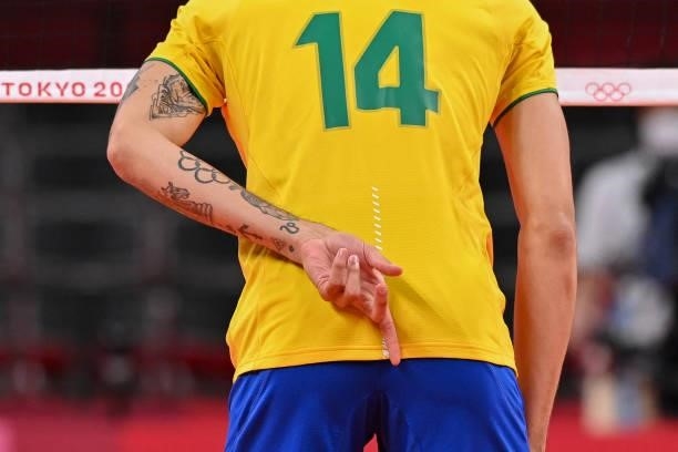 Brazil's Douglas Correia de Souza gestures before a point in the men's preliminary round pool B volleyball match between Brazil and Russia during the...