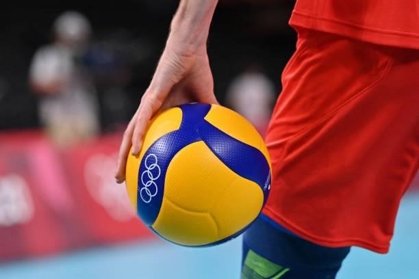 Russian player holds a ball in the men's preliminary round pool B volleyball match between Brazil and Russia during the Tokyo 2020 Olympic Games at...