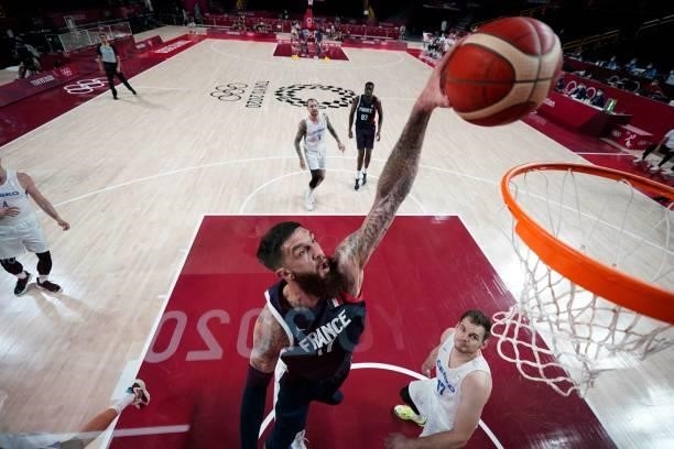 France's Vincent Poirier goes for a dunk past Czech Republic's Jaromir Bohacik in the men's preliminary round group A basketball match between France...