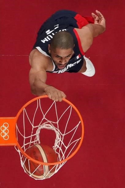 France's Nicolas Batum scores a basket in the men's preliminary round group A basketball match between France and Czech Republic during the Tokyo...