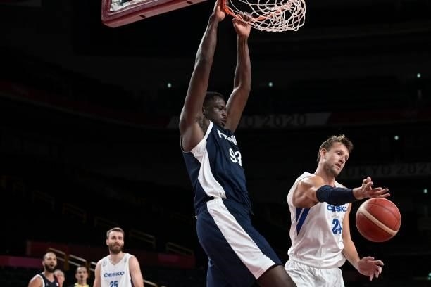 France's Moustapha Fall goes for a dunk past Czech Republic's Jan Vesely in the men's preliminary round group A basketball match between France and...