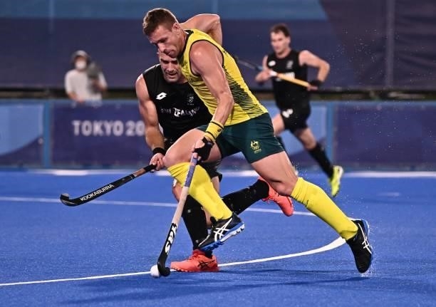 Australia's Tom Joseph Wickham is challenged by New Zealand's Dane Lett during their men's pool A match of the Tokyo 2020 Olympic Games field hockey...