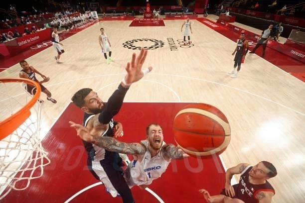 Czech Republic's Patrik Auda reacts as France's Vincent Poirier tries to block in the men's preliminary round group A basketball match between France...