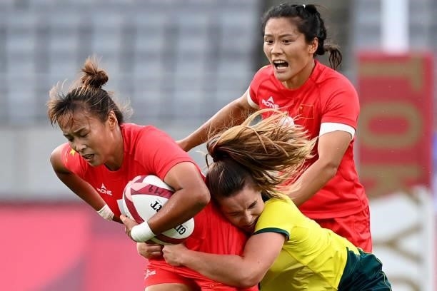 China's Yu Xiaoming is tackled in the women's pool C rugby sevens match between Australia and China during the Tokyo 2020 Olympic Games at the Tokyo...