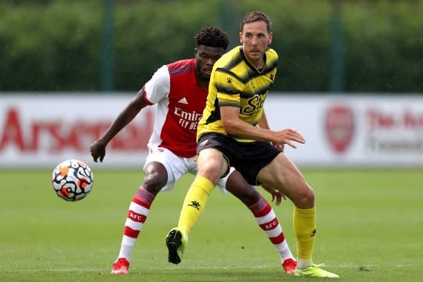 Thomas Partey of Arsenal and Dan Gosling of Watford during the Pre-Season Friendly between Arsenal and Watford at London Colney on July 28, 2021 in...