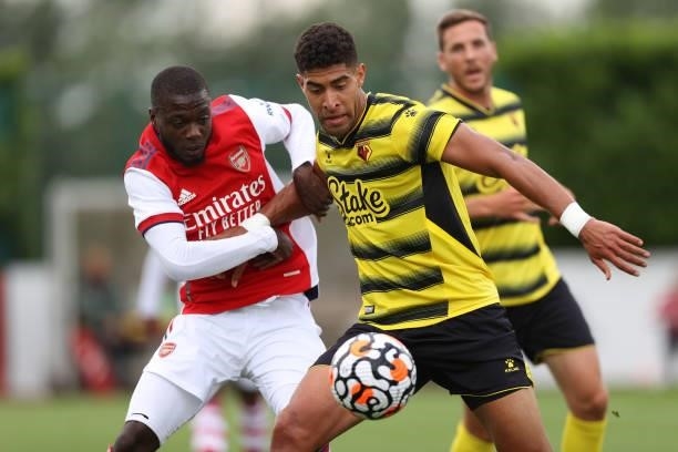 Pepe of Arsenal and Adam Masina of Watford during the Pre-Season Friendly between Arsenal and Watford at London Colney on July 28, 2021 in St Albans,...
