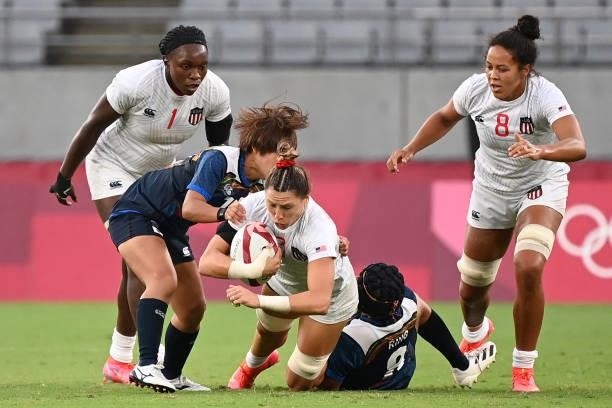 S Abbey Gastaitis is tackled by Japan's Mio Yamanaka during the women's pool C rugby sevens match between the USA and Japan during the Tokyo 2020...