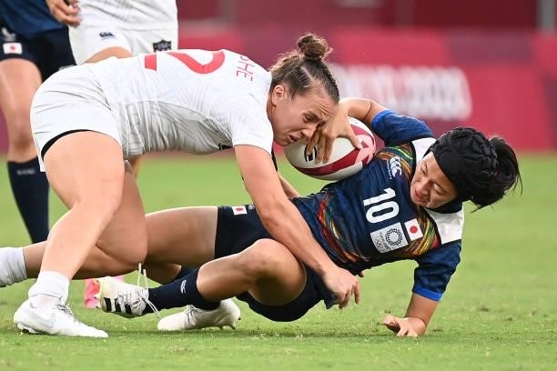 Japan's Hana Nagata is tackled by USA's Kristi Kirshe during the women's pool C rugby sevens match between the USA and Japan during the Tokyo 2020...