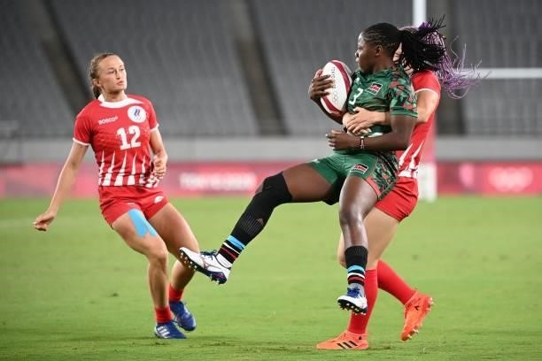 Kenya's Sheila Chajira is tackled by Russia's Alena Tiron, as Anna Baranchuk during the women's pool A rugby sevens match between the Russia and...