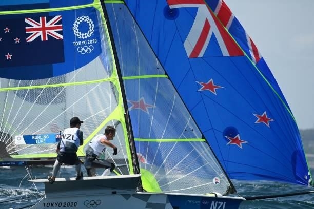 New Zealands Blair Tuke and Peter Burling take part in the men's skiff 49er race during the Tokyo 2020 Olympic Games sailing competition at the...