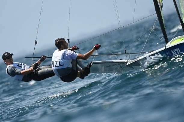 New Zealands Blair Tuke and Peter Burling take part in the men's skiff 49er race during the Tokyo 2020 Olympic Games sailing competition at the...