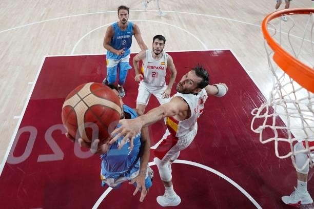 Spain's Rudy Fernandez tries to block as Argentina's Facundo Campazzo goes to the basket in the men's preliminary round group C basketball match...