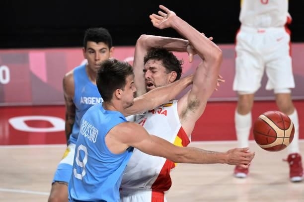Spain's Pau Gasol Saez and Argentina's Nicolas Brussino fight for the ball in the men's preliminary round group C basketball match between Spain and...