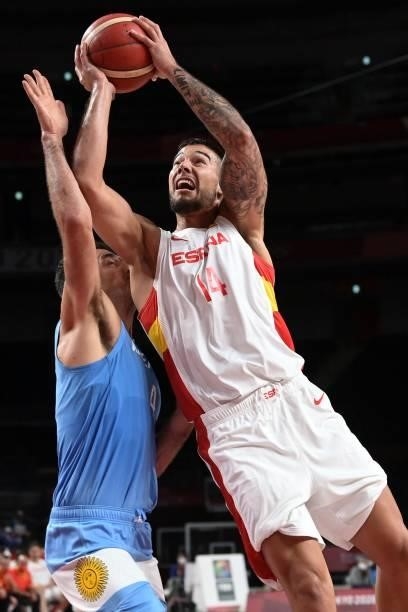 Spain's Willy Hernangomez Geuer goes to the basket past Argentina's Luis Scola in the men's preliminary round group C basketball match between Spain...