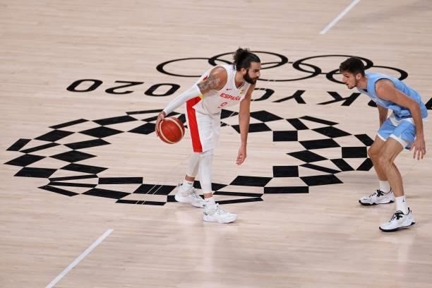 Spain's Ricky Rubio dribbles the ball next to Argentina's Leandro Nicolas Bolmaro in the men's preliminary round group C basketball match between...