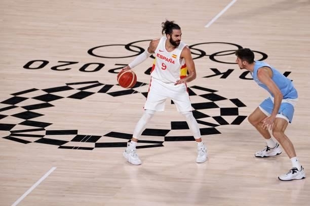 Spain's Ricky Rubio dribbles the ball next to Argentina's Leandro Nicolas Bolmaro in the men's preliminary round group C basketball match between...