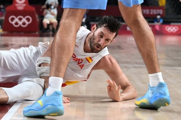 Spain's Rudy Fernandez falls on the court during a play in the men's preliminary round group C basketball match between Spain and Argentina of the...