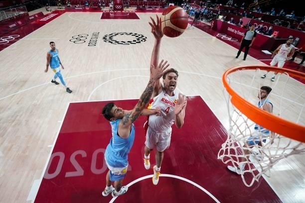 Spain's Pau Gasol Saez goes to the basket past Argentina's Gabriel Deck in the men's preliminary round group C basketball match between Spain and...