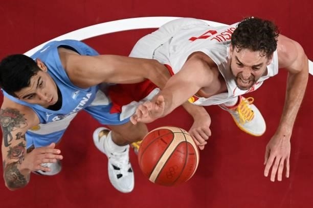Spain's Pau Gasol Saez and Argentina's Gabriel Deck fight for a rebound during the men's preliminary round group C basketball match between Spain and...