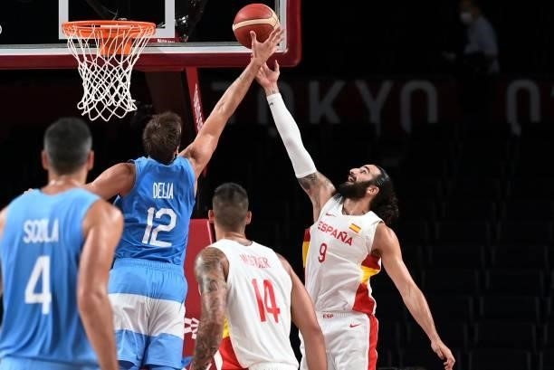 Spain's Ricky Rubio jumps for the ball with Argentina's Marcos Delia in the men's preliminary round group C basketball match between Spain and...