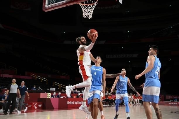 Spain's Ricky Rubio goes to the basket past Argentina's Luis Scola in the men's preliminary round group C basketball match between Spain and...