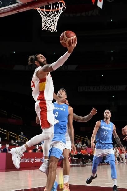 Spain's Ricky Rubio goes to the basket past Argentina's Luis Scola in the men's preliminary round group C basketball match between Spain and...