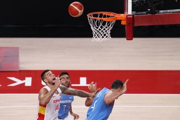 Spain's Willy Hernangomez Geuer , Argentina's Facundo Campazzo and Luis Scola run for the ball in the men's preliminary round group C basketball...