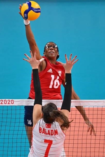 S Foluke Akinradewo hits the ball in the women's preliminary round pool B volleyball match between USA and Turkey during the Tokyo 2020 Olympic Games...