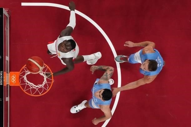 Spain's Usman Garuba , Argentina's Gabriel Deck and Marcos Delia run for the rebound in the men's preliminary round group C basketball match between...