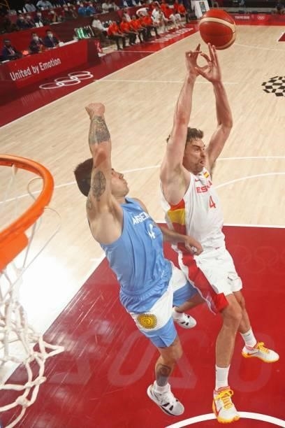 Argentina's Gabriel Deck and Spain's Pau Gasol Saez jump for the ball in the men's preliminary round group C basketball match between Spain and...