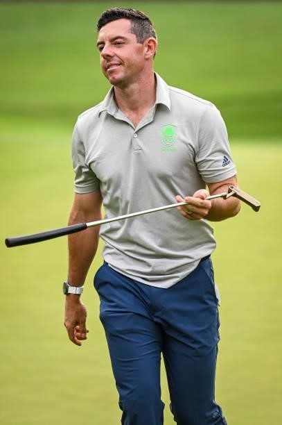 Rory McIlroy of Team Ireland smiles and reacts with his Scotty Cameron putter on the 17th hole green during the first round of Mens Individual Stroke...