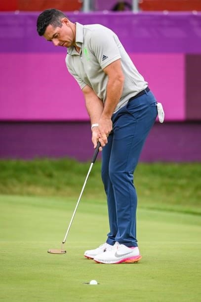 Rory McIlroy of Team Ireland taps in his par putt with his Scotty Cameron putter on the 18th hole green during the first round of Mens Individual...
