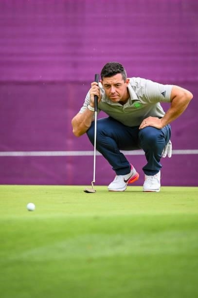 Rory McIlroy of Team Ireland reads his putt with his Scotty Cameron putter on the 16th hole green during the first round of Mens Individual Stroke...