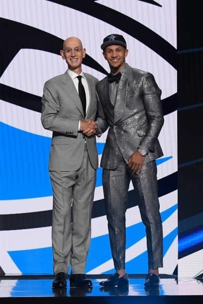 Jalen Suggs shakes hands with NBA Commissioner Adam Silver after being selected number five overall by the Orlando Magic during the 2021 NBA Draft on...