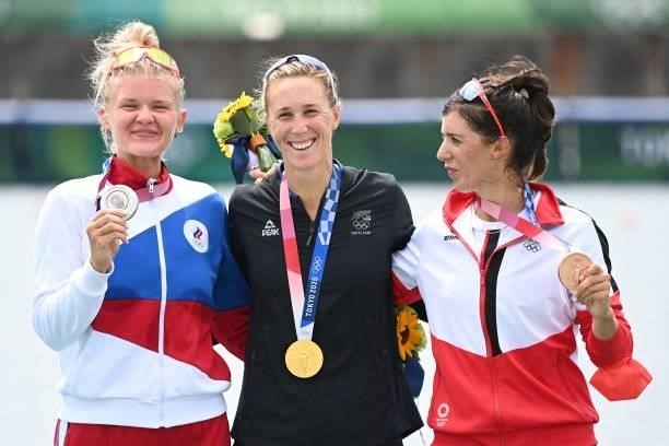 Silver medalist Russia's Hanna Prakhatsen, Gold medalist New Zealand's Emma Twigg and Bronze medalist Austria's Magdalena Lobnig pose on the podium...