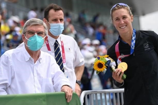 The President of the International Olympic Committee Thomas Bach poses for photo with the gold medalist New Zealand's Emma Twigg following the...