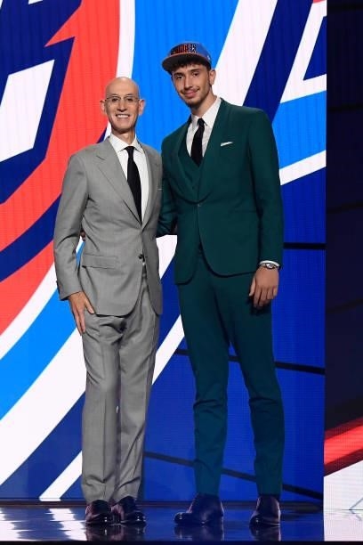 Alperen Sengun shakes hands with NBA Commissioner Adam Silver after being selected number sixteen overall during the 2021 NBA Draft on July 29, 2021...
